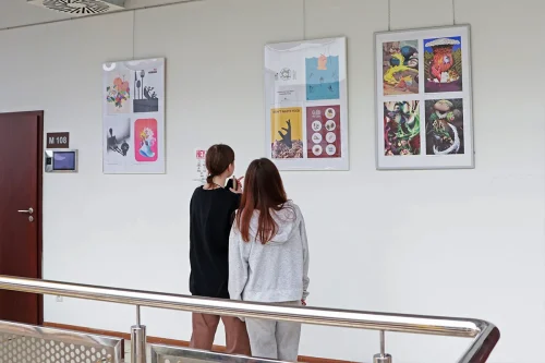 Studenci Projektowania graficznego II stopnia we WSIiZ w Rzeszowie oglądają prace graficzne podczas wystawy
